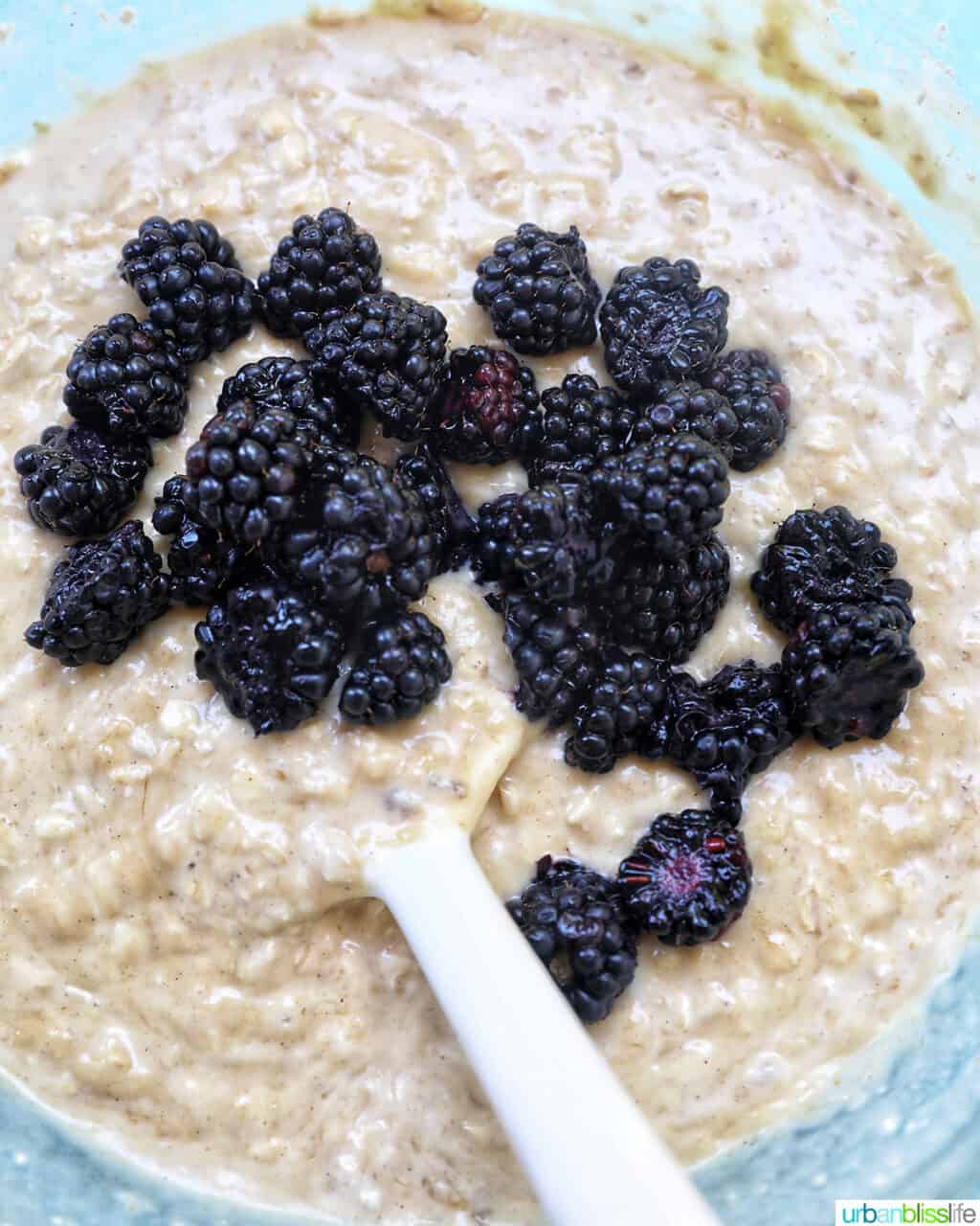 gently folding blackberries into batter.