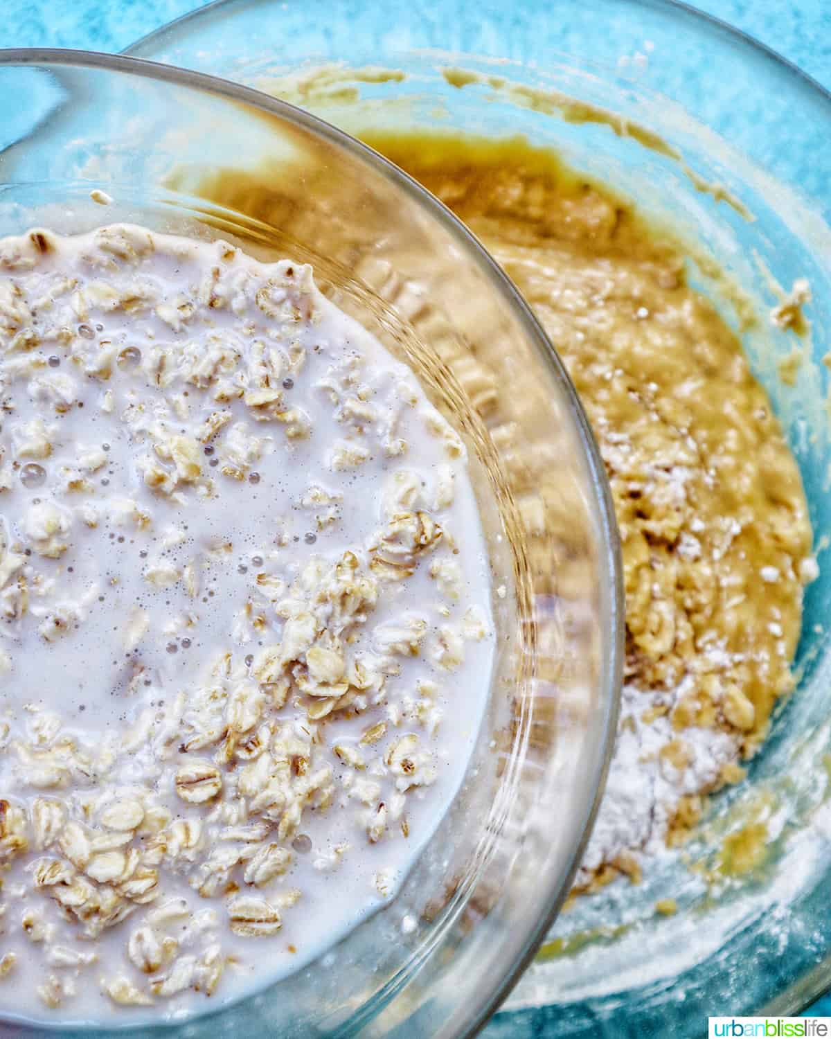 bowl of oatmeal milk mixture over a bowl of batter.