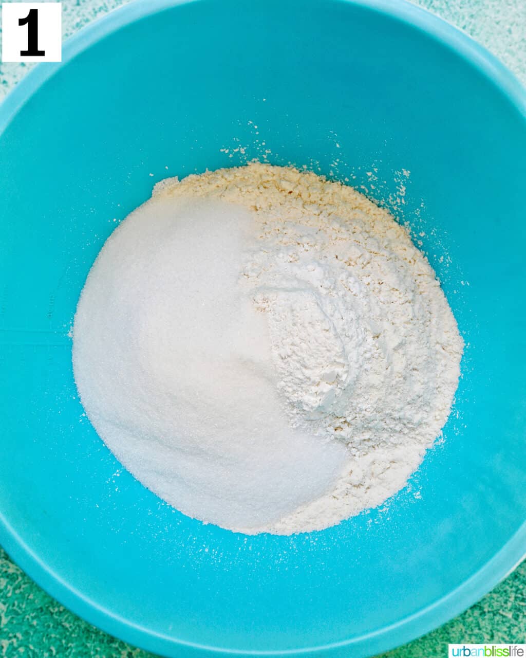 blue bowl with dry ingredients to make lemon blueberry cookies.