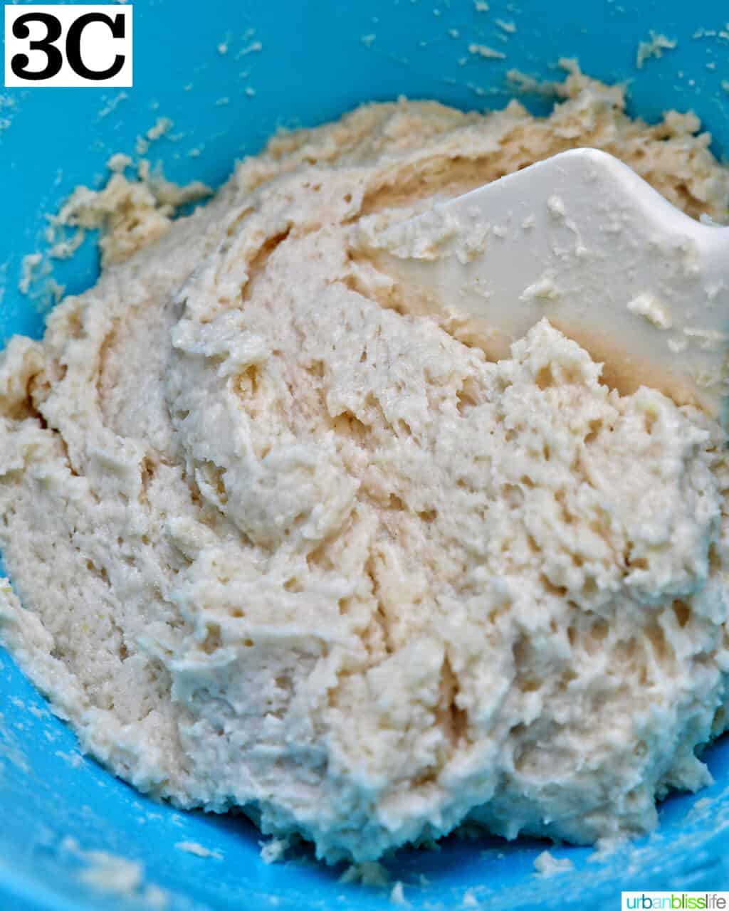 dough in a blue bowl to make lemon blueberry cookies.
