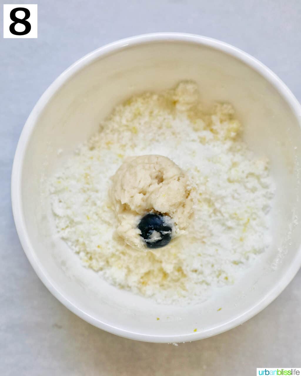 lemon blueberry cookie dough ball in lemon sugar.