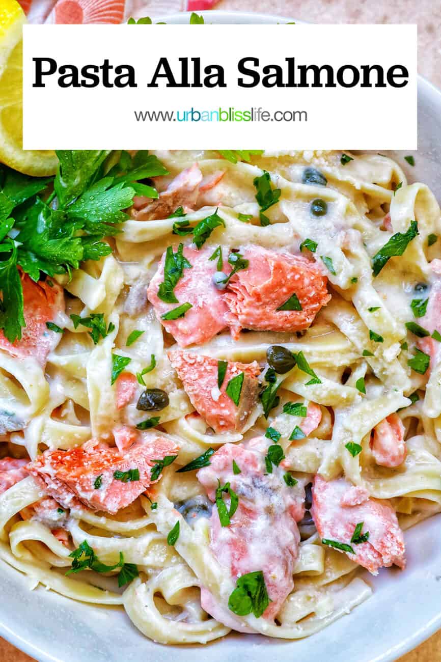 pasta alla salmone with garnishes of parsley and lemon slices in a white bowl with title text that reads "pasta alla salmone."