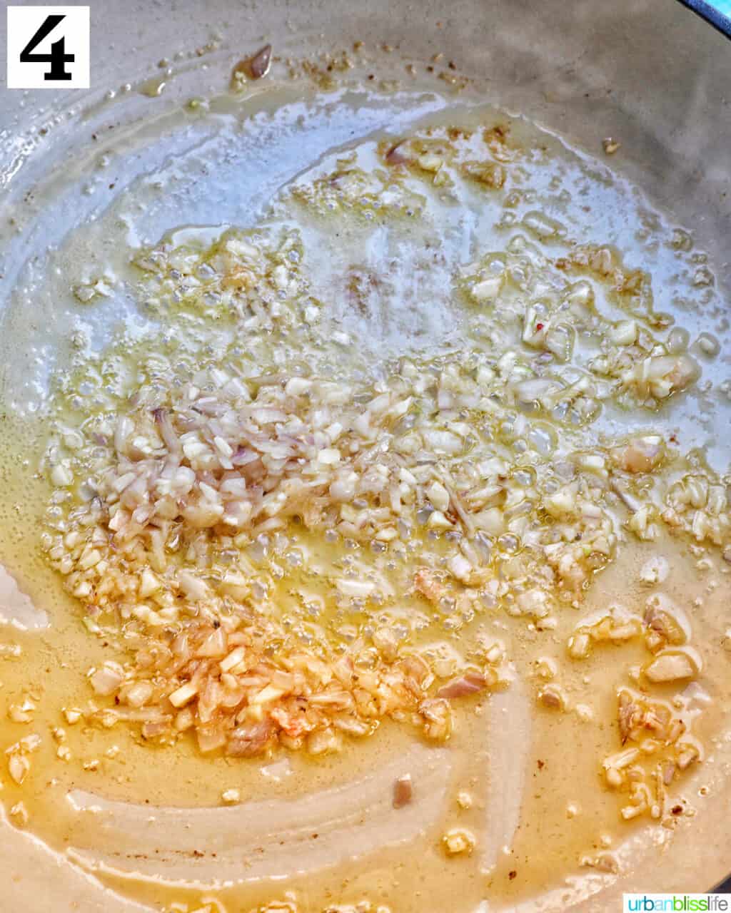 cooking garlic in a white skillet.