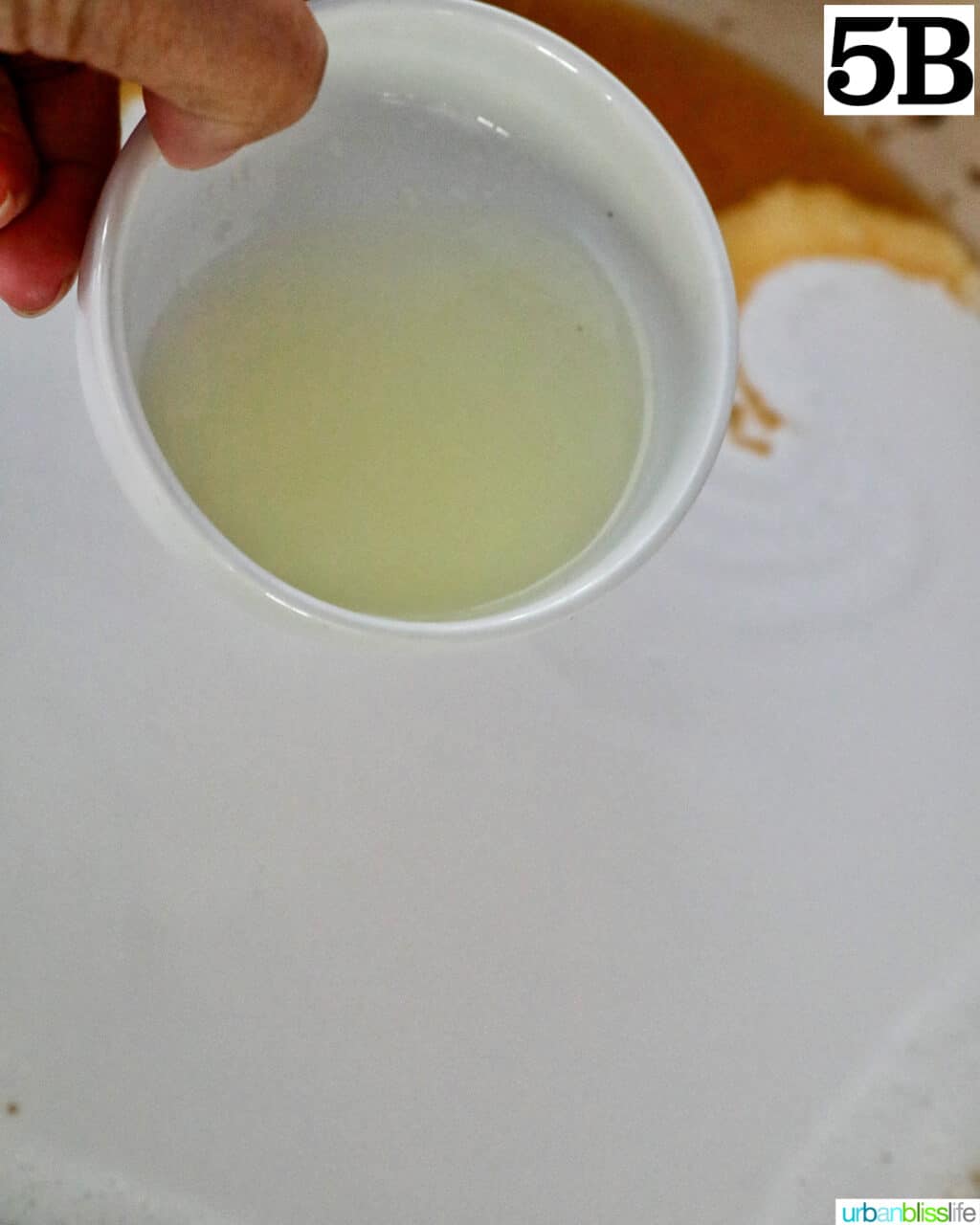 adding lemon juice into a pan.