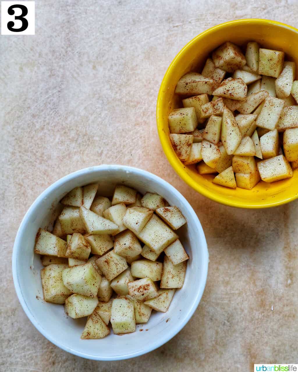 two bowls with seasoned diced apples in them.
