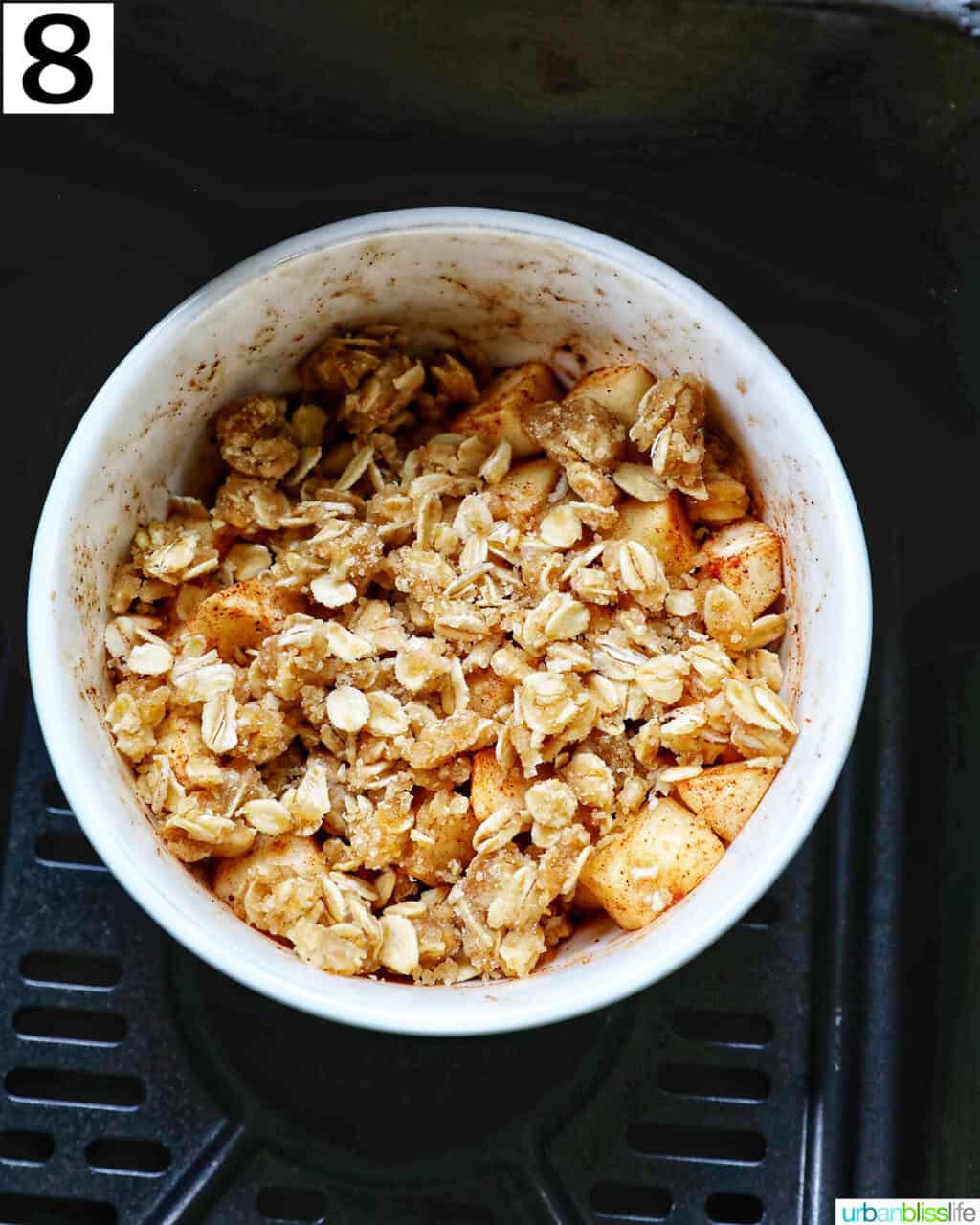 bowl of Air Fryer Apple Crisp in an air fryer basket.