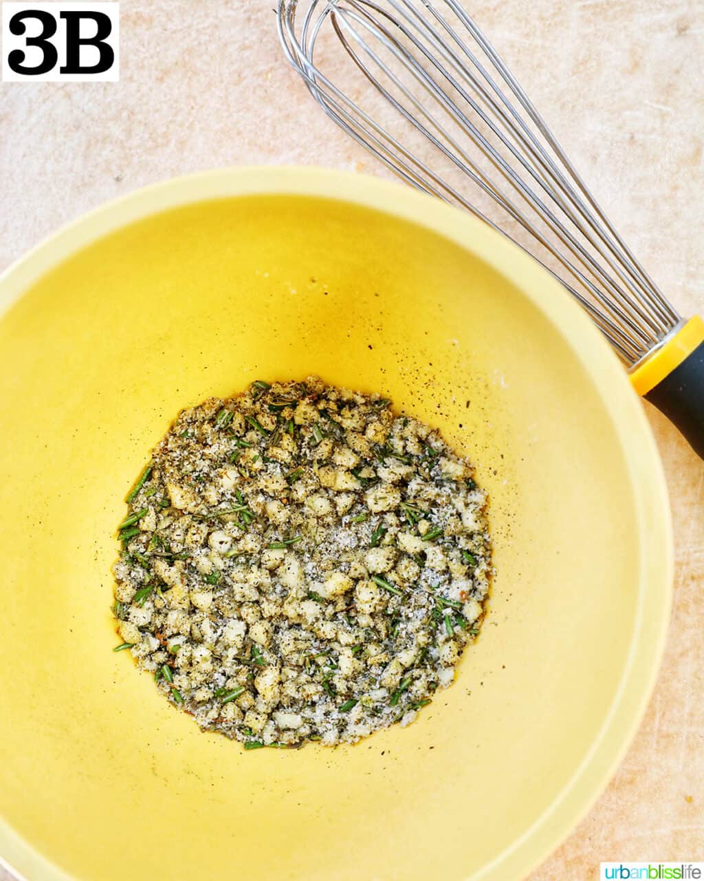 seasoning mix in a yellow bowl with a whisk.
