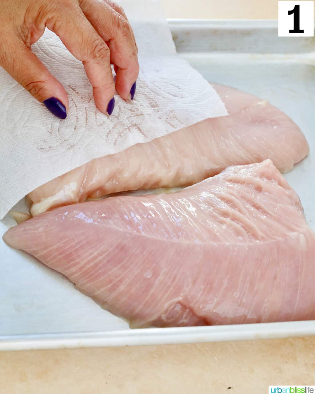 patting turkey tenderloins dry with paper towels.