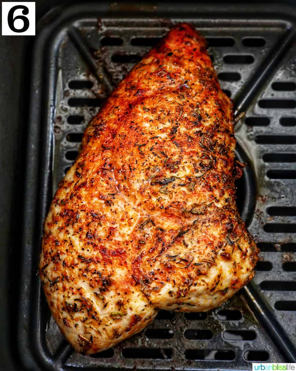 turkey tenderloin cooked in an air fryer basket.