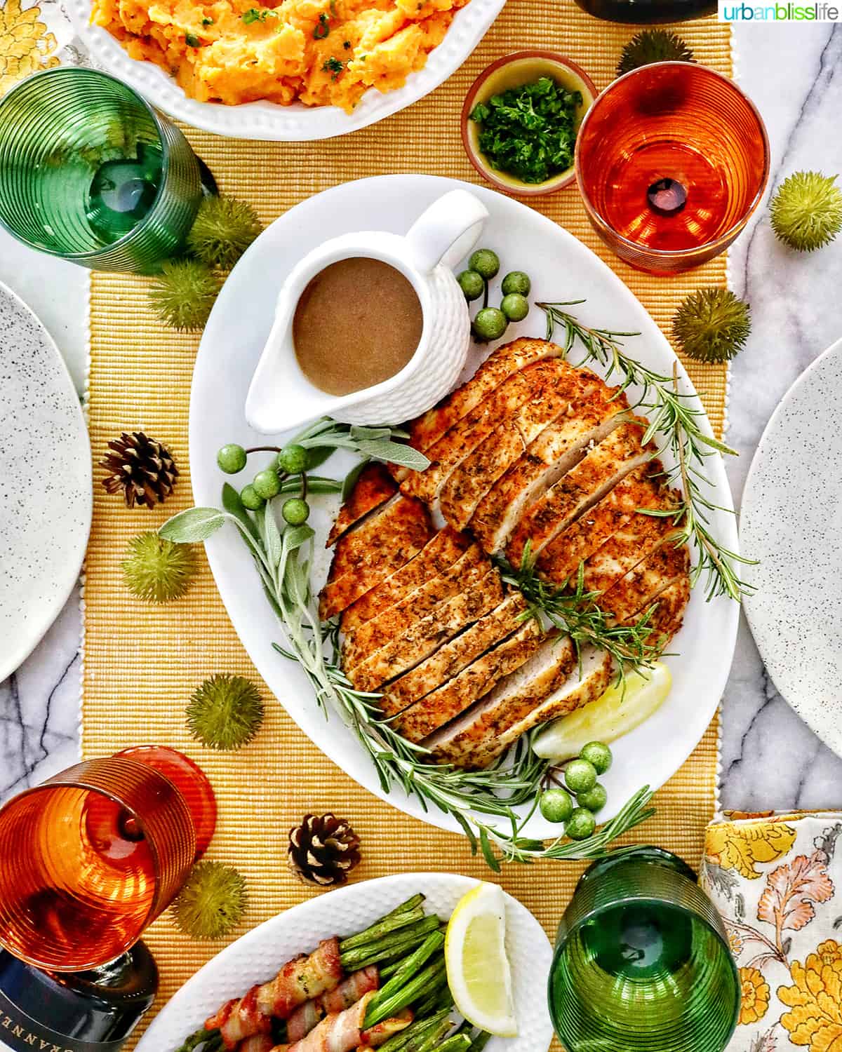 turkey tenderloin tablesetting with sides and glasses.