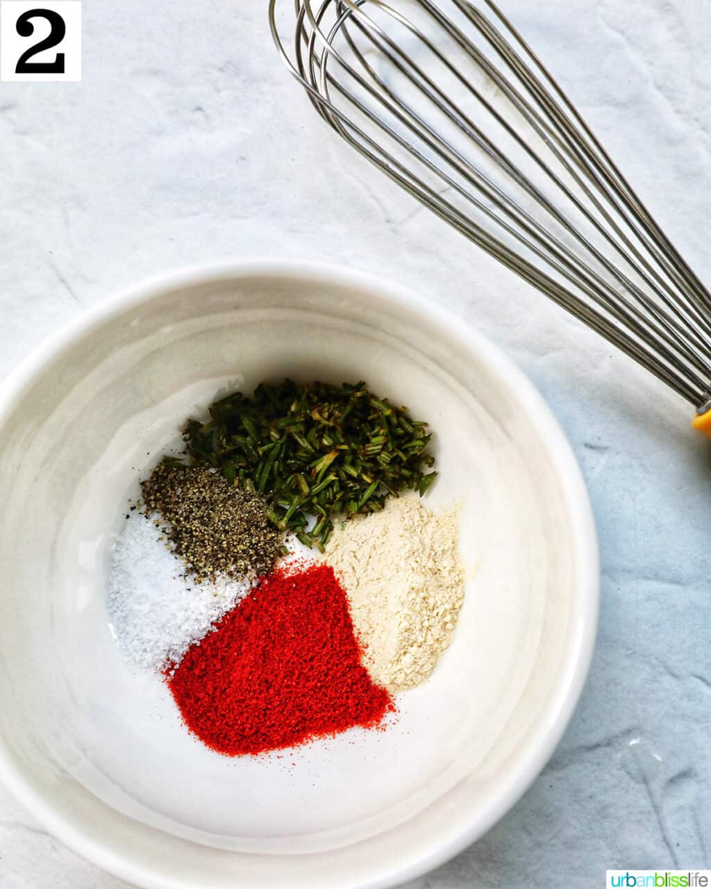 whisk and a bowl of spices.