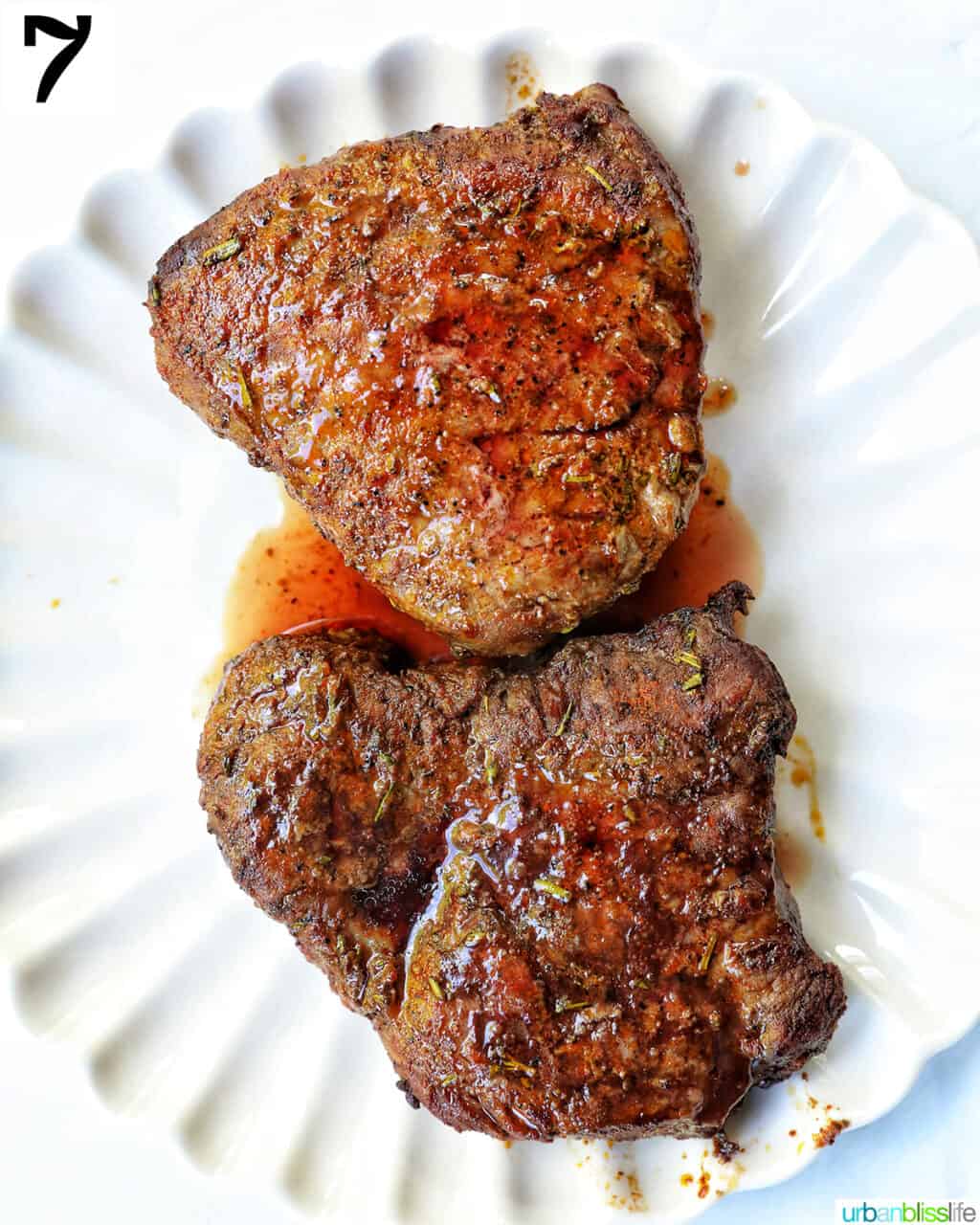 two cooked filet mignons on a plate.
