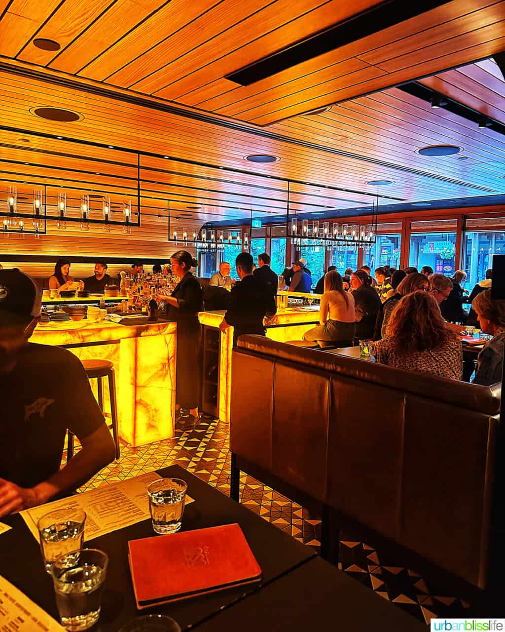 busy bar and dining area at Bar Oso restaurant in Whistler BC Canada.