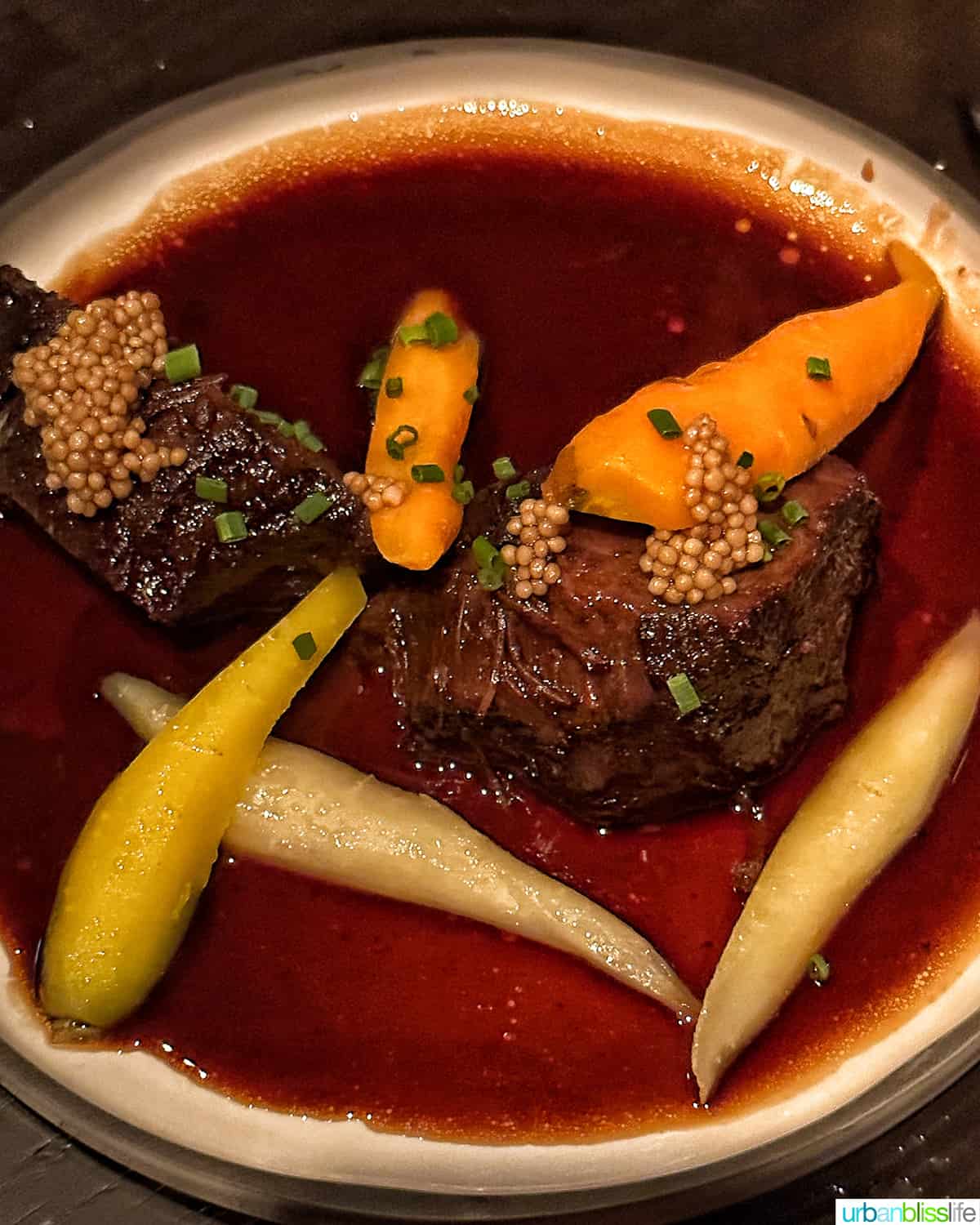 Wagyu beef cheeks with carrots and parsnips at Bar Oso restaurant in Whistler BC Canada.