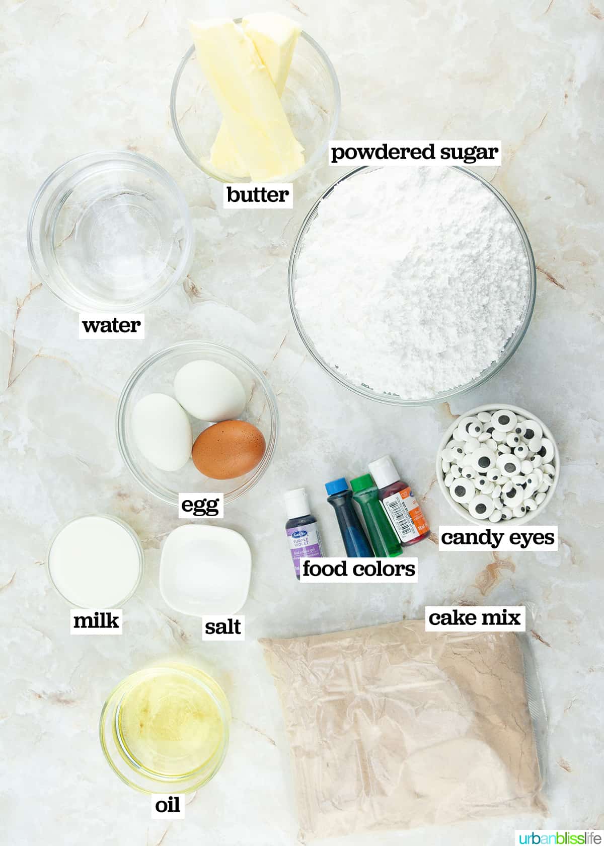 several bowls of ingredients to make Halloween monster cupcakes.