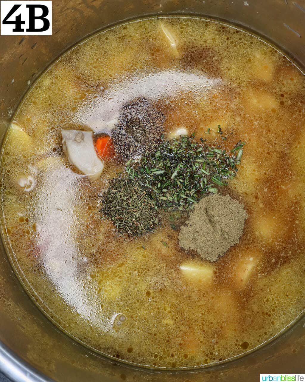 herbs on top of chicken broth, chicken, and vegetables in an instant pot.