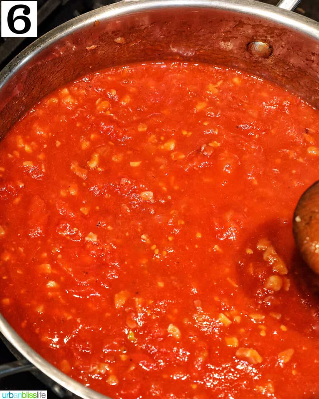tomatoes cooking in a large saucepan.