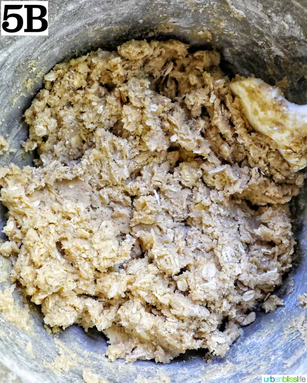 cookie batter dough mixed together in a stand mixer bowl.