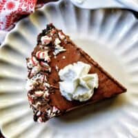 slice of Chocolate Peppermint Pie on a scalloped plate.