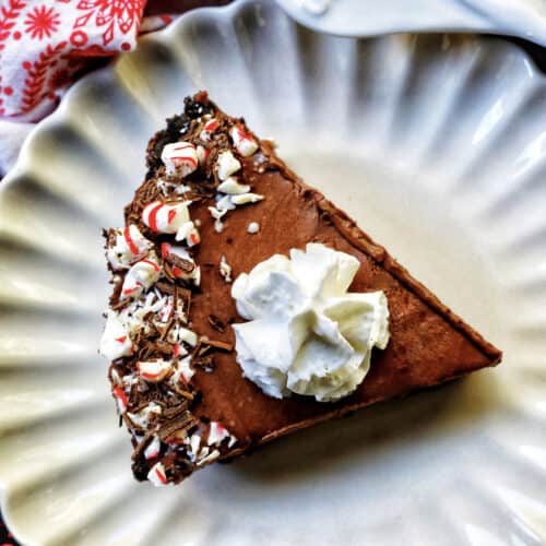 slice of Chocolate Peppermint Pie on a scalloped plate.
