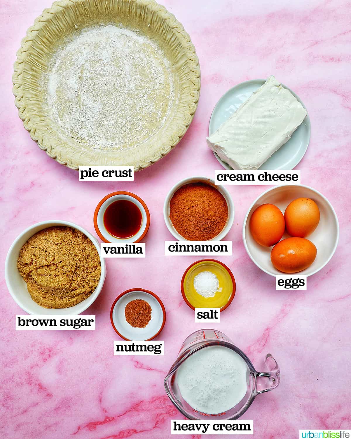 bowls of ingredients to make cinnamon pie on a pink table.