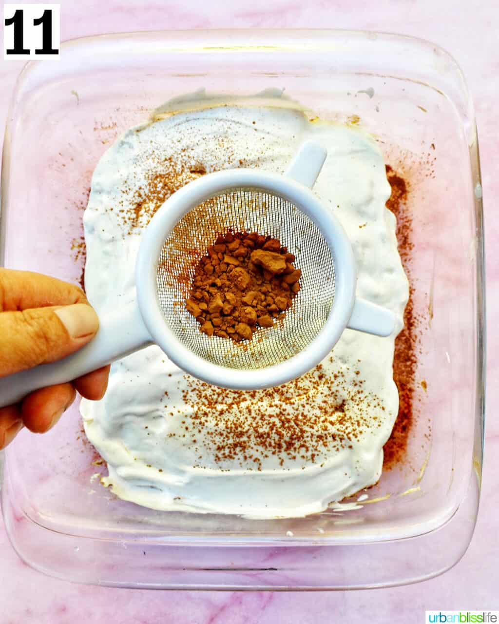 spreading cocoa powder on tiramisu