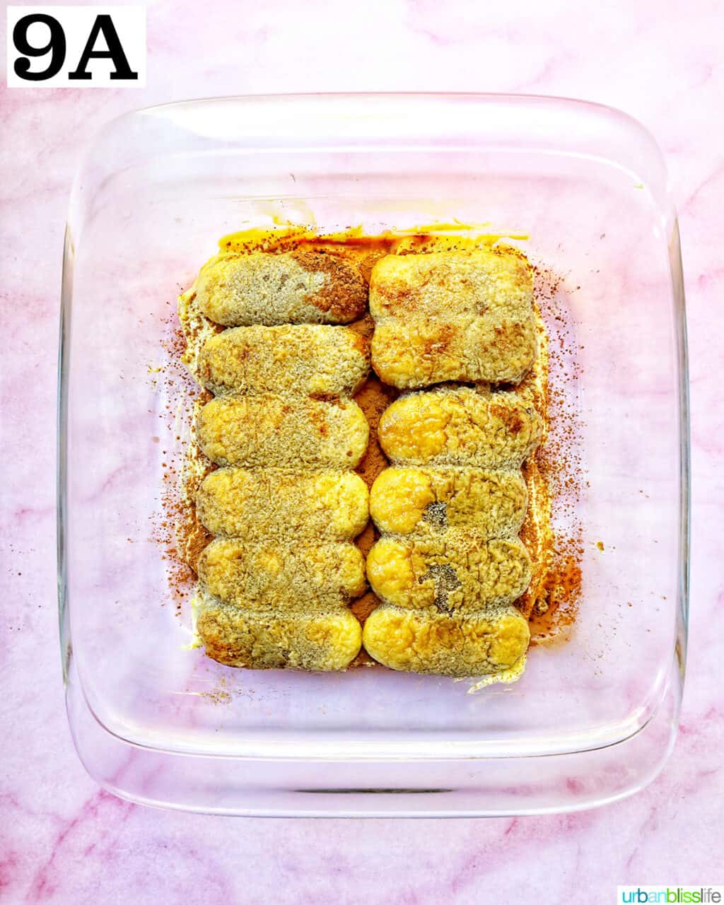 placing ladyfingers in glass baking dish for tiramisu