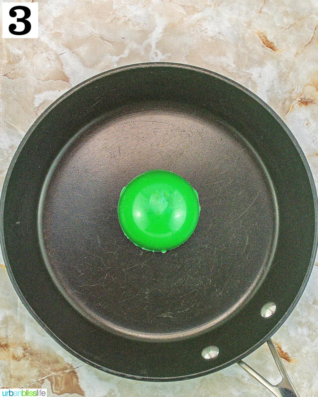 green grinch hot cocoa bomb on a pan.