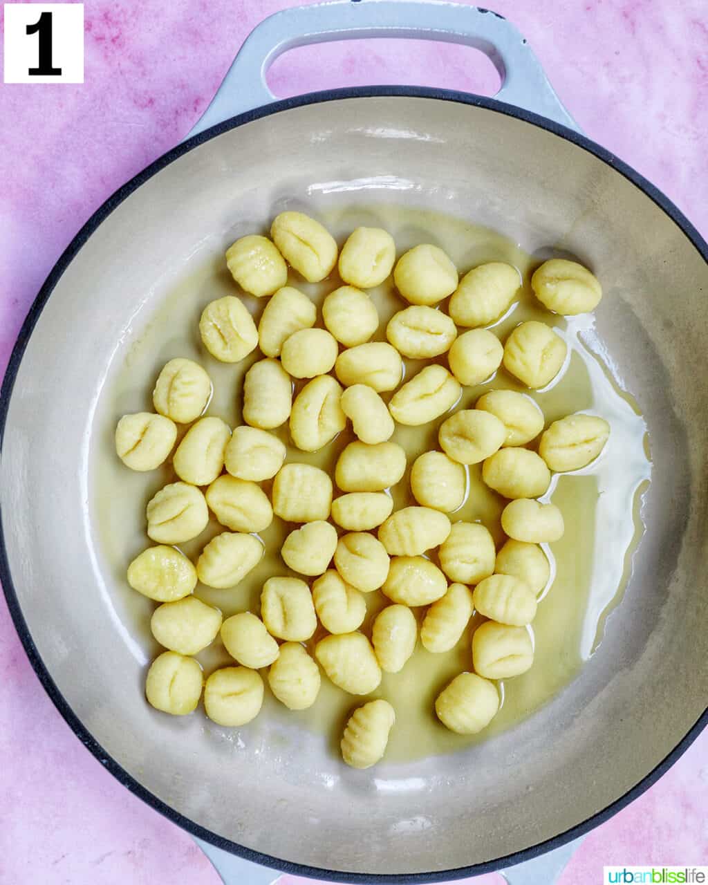 gnocchi cooking in a skillet.
