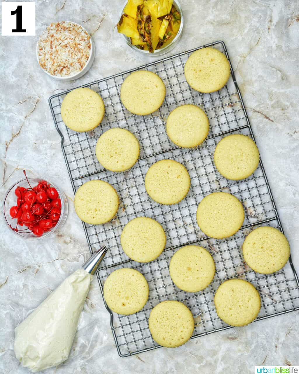 pina colada cupcakes unfrosted on a wire rack.