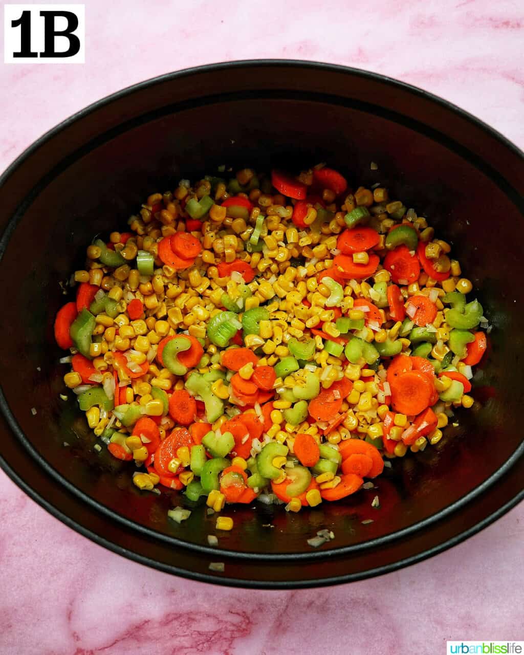 celery, carrots, corn, onions, and spices in a Dutch oven.
