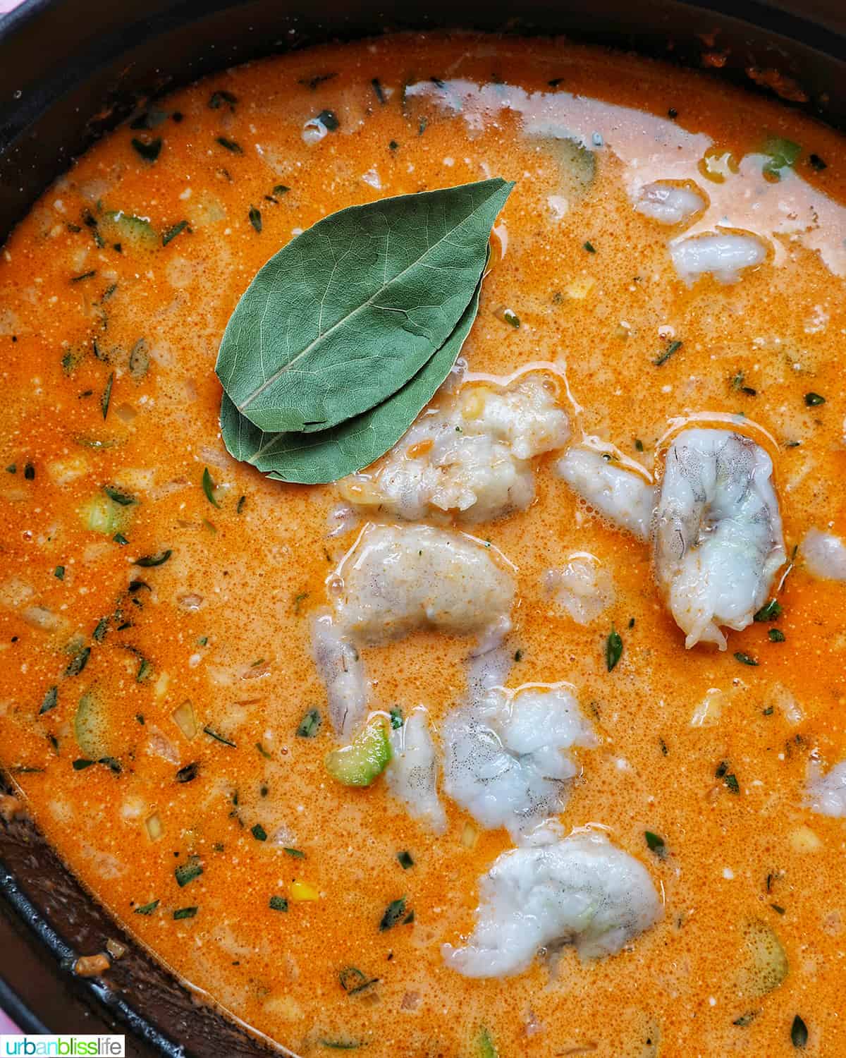 bay leaves and shrimp added to bisque base in a large dutch oven.