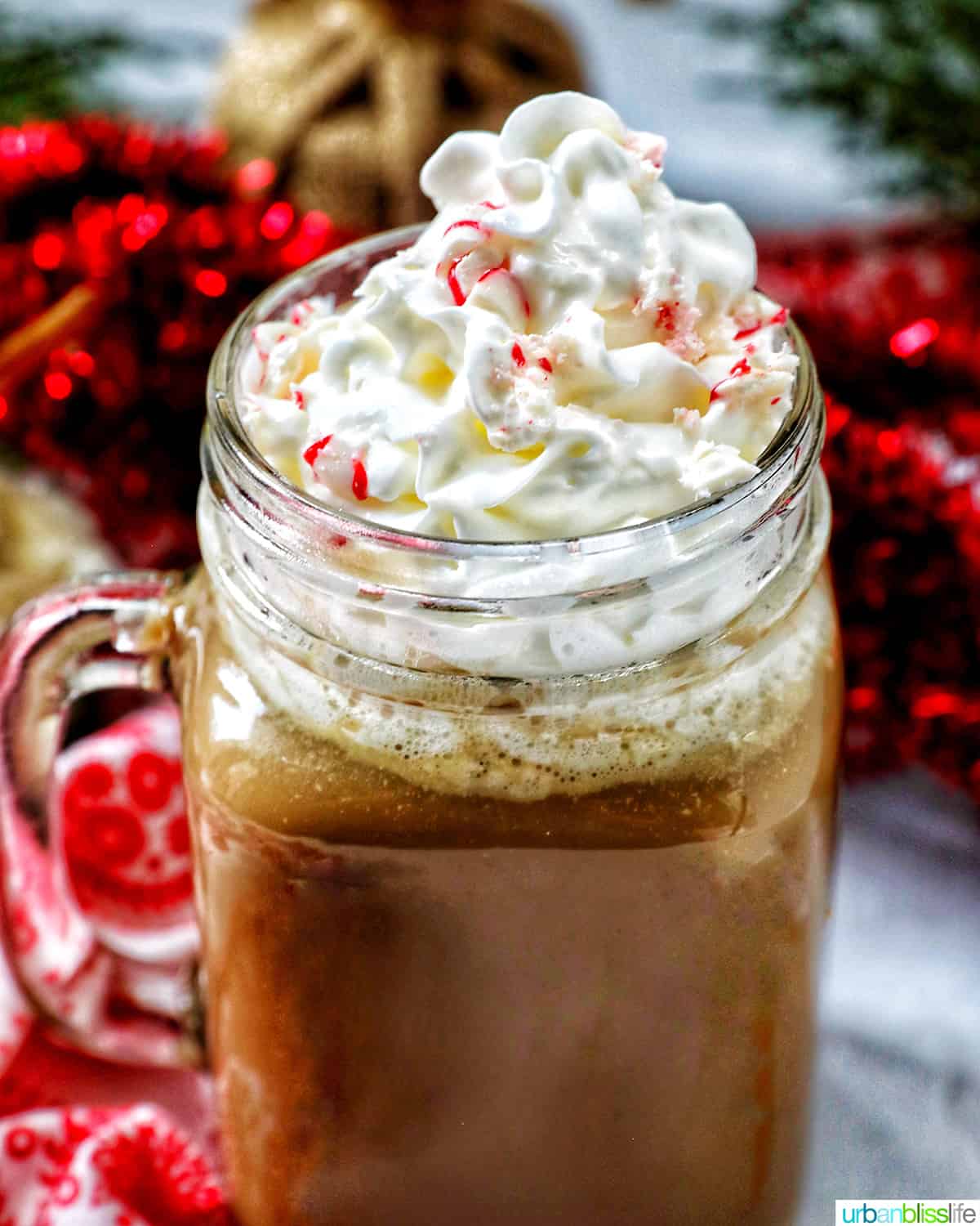 glass mug of white chocolate peppermint mocha with whipped cream.