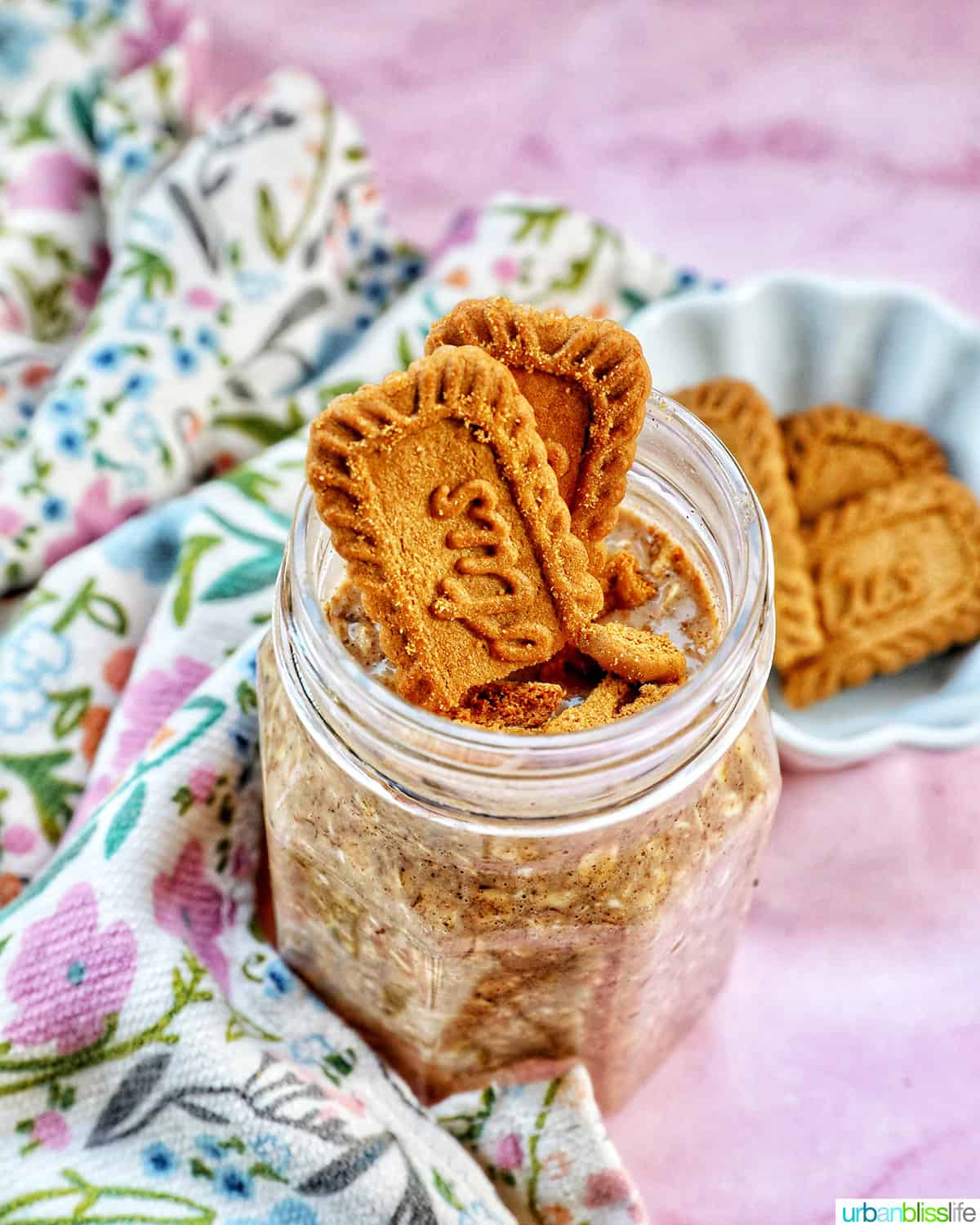 Biscoff overnight oats in a jar with crumbled Biscoff cookies on top.