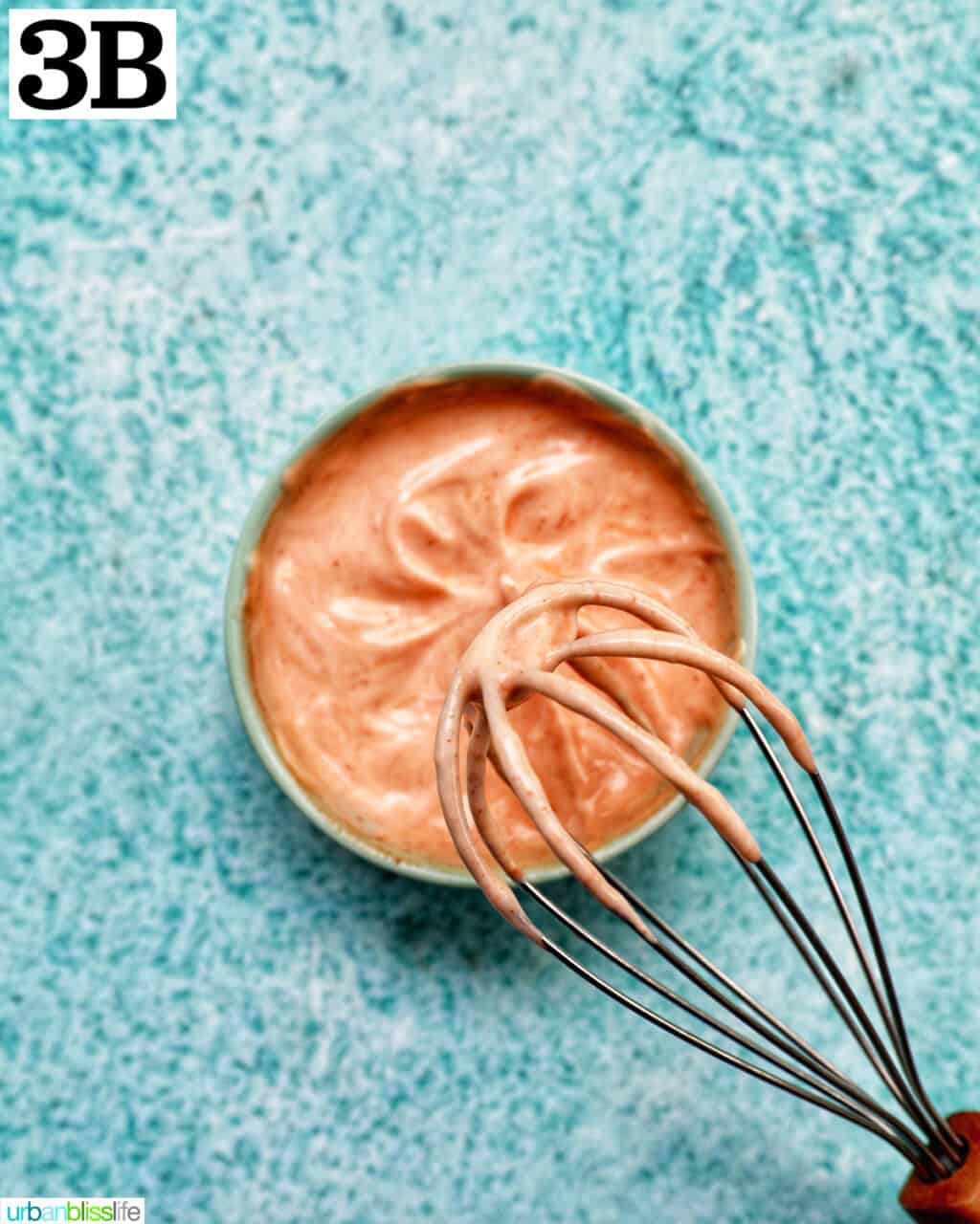 bowl of sriracha mayo and a whisk.