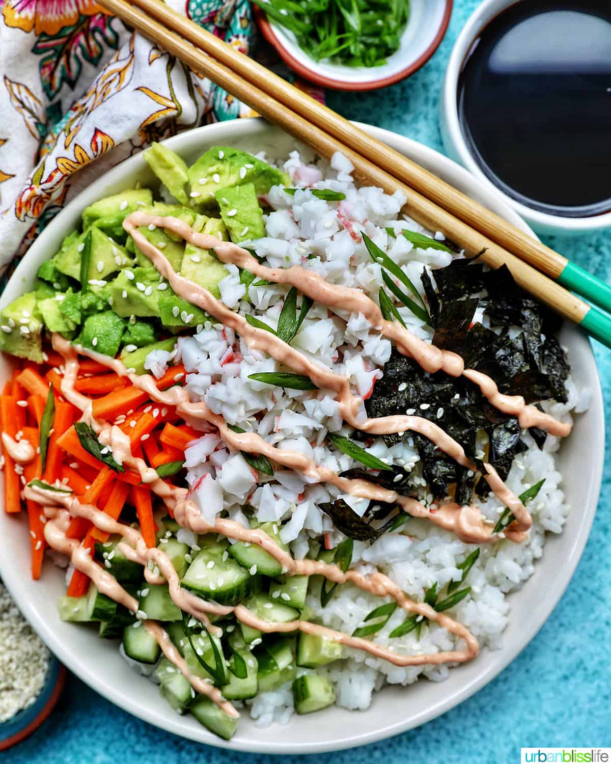 Carlifornia Sushi Bowls with crab, cucumbers, carrots, avocado, nori over white rice and drizzled with a sriracha mayo.