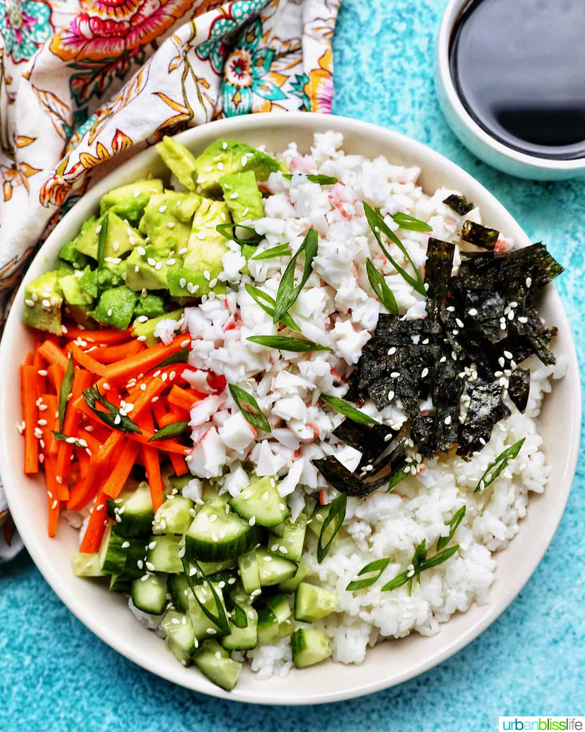 Carlifornia Sushi Bowls with crab, cucumbers, carrots, avocado, nori over white rice and drizzled with a sriracha mayo.