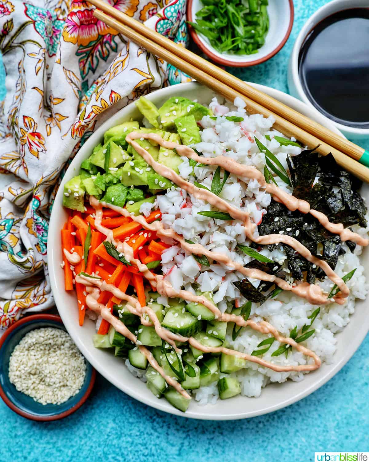 Carlifornia Sushi Bowls with crab, cucumbers, carrots, avocado, nori over white rice and drizzled with a sriracha mayo.