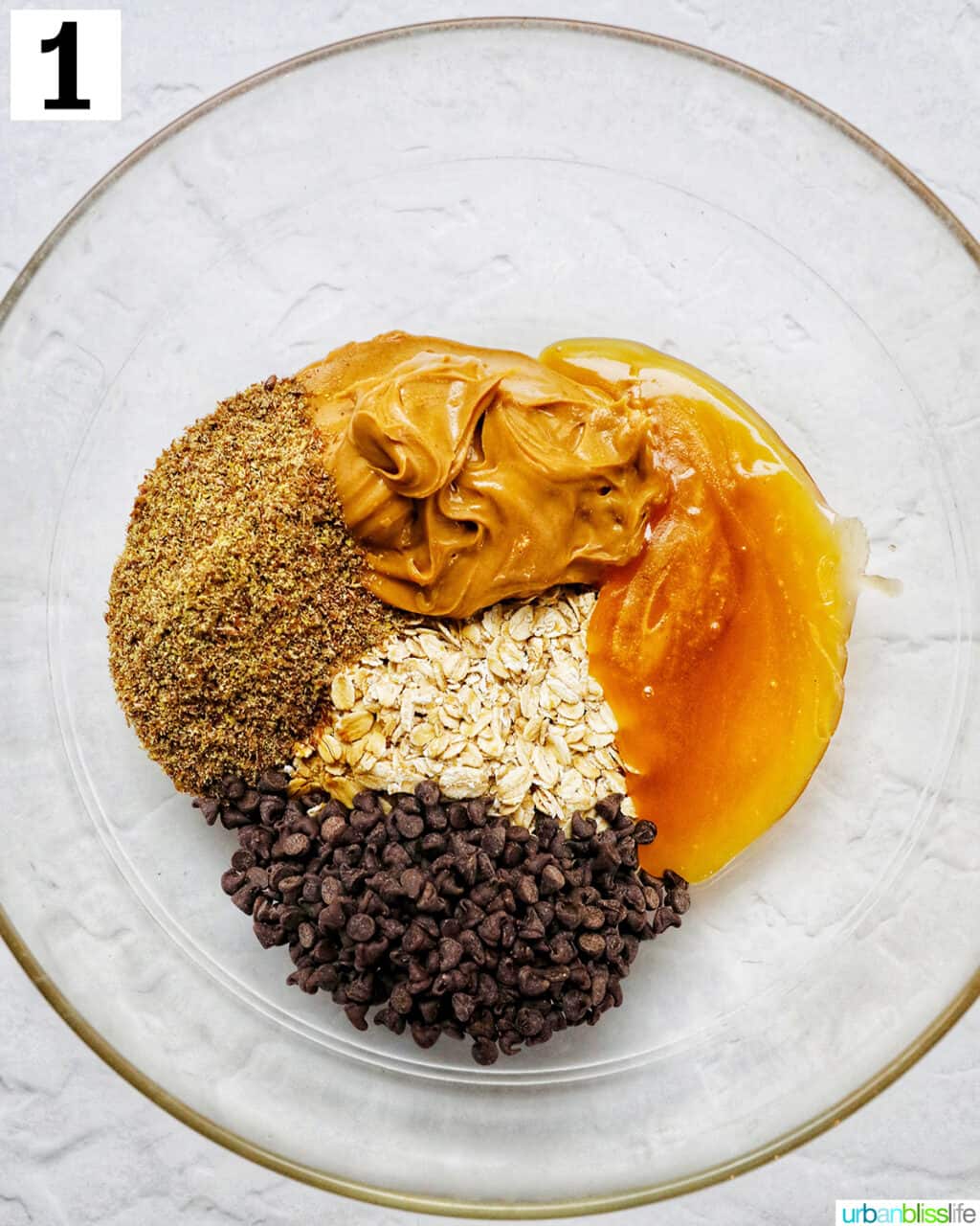 ingredients to make Peanut Butter Chocolate Chip Oatmeal Ball mix in a glass bowl.