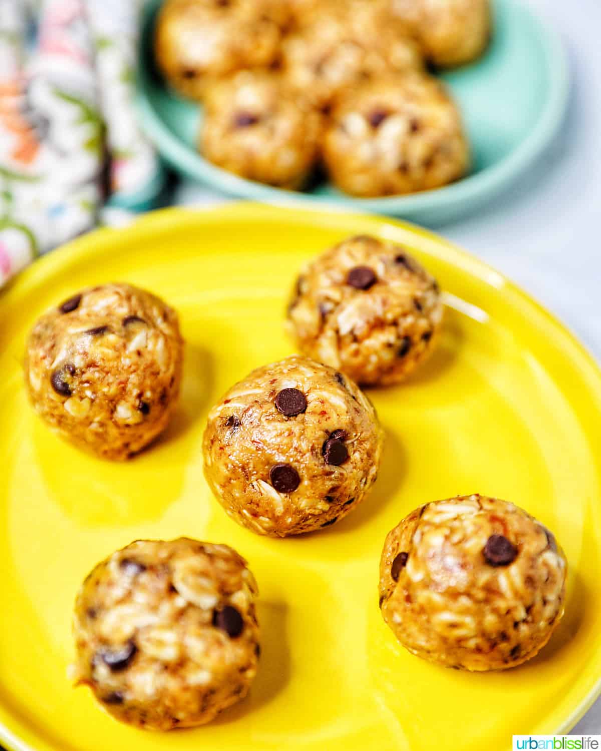 Peanut Butter Chocolate Chip Oatmeal Balls on a bright yellow plate.