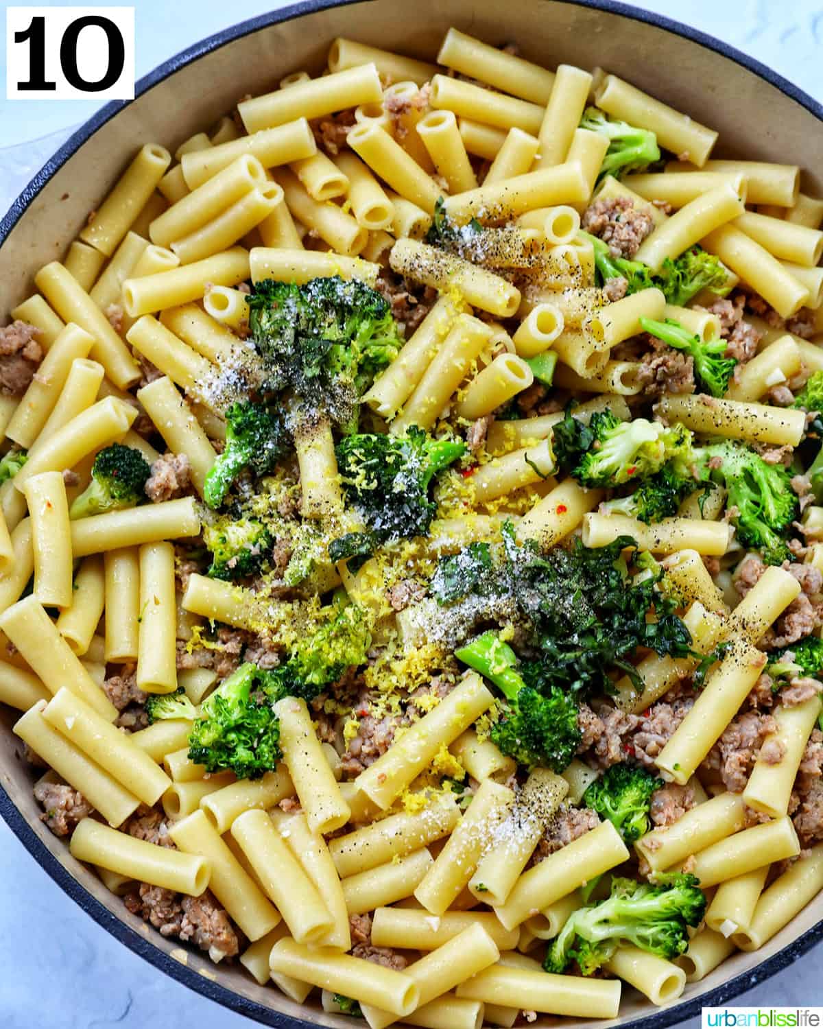 a skillet of broccoli and Italian sausage.