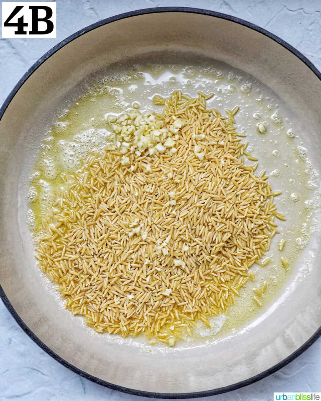 uncooked orzo and garlic in a large skillet.