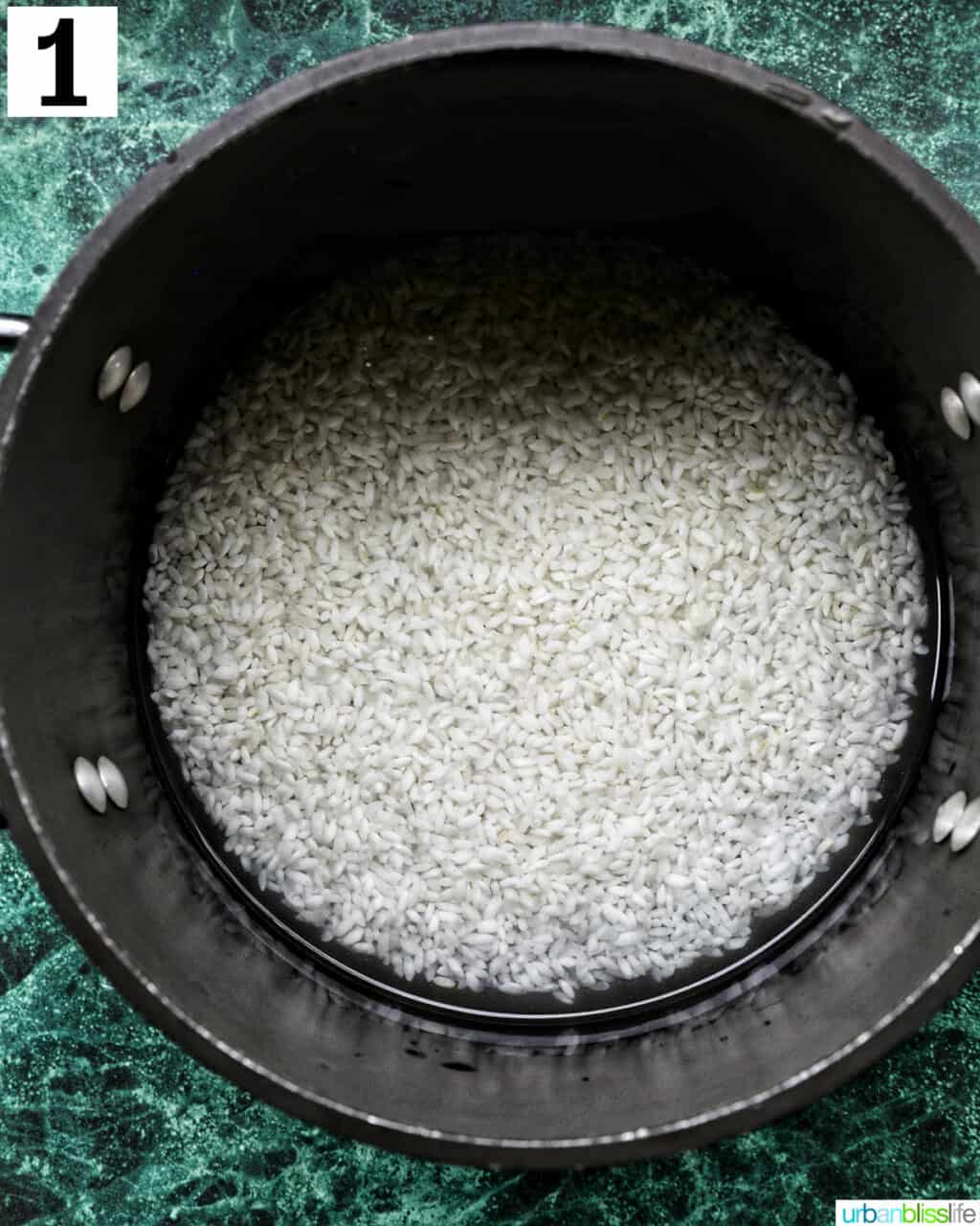 rice cooking in water in a pot.
