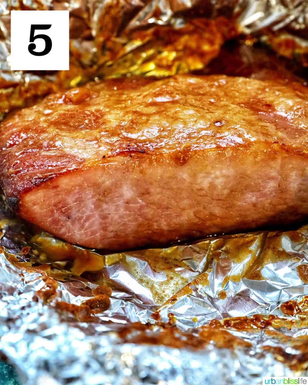 cooked ham in aluminum foil.