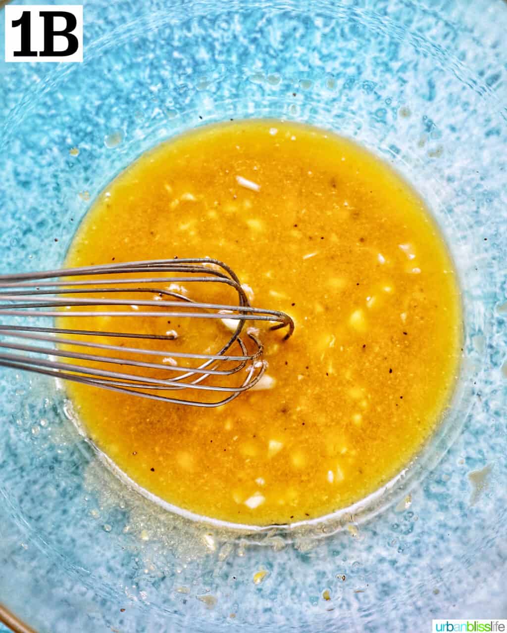 lemon mustard vinaigrette dressing in a large glass bowl.
