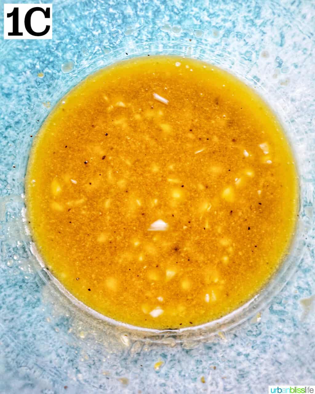 lemon mustard vinaigrette dressing in a large glass bowl.