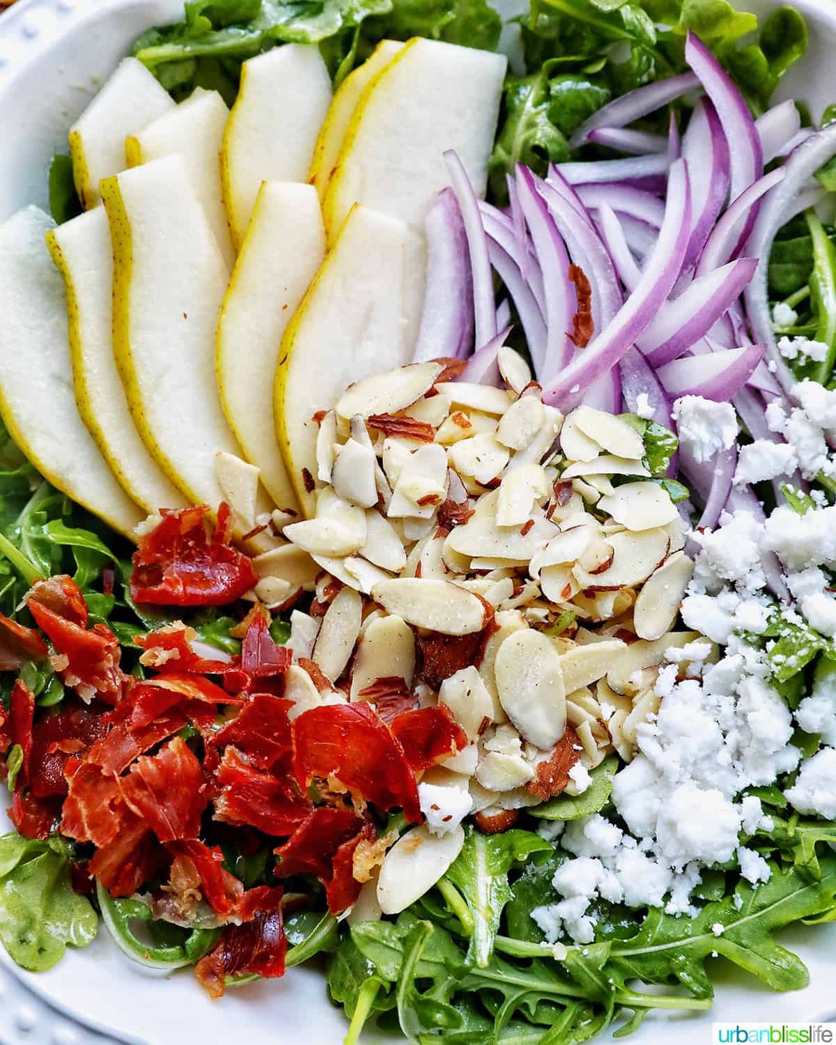 closeup of pear arugula salad ingredients.