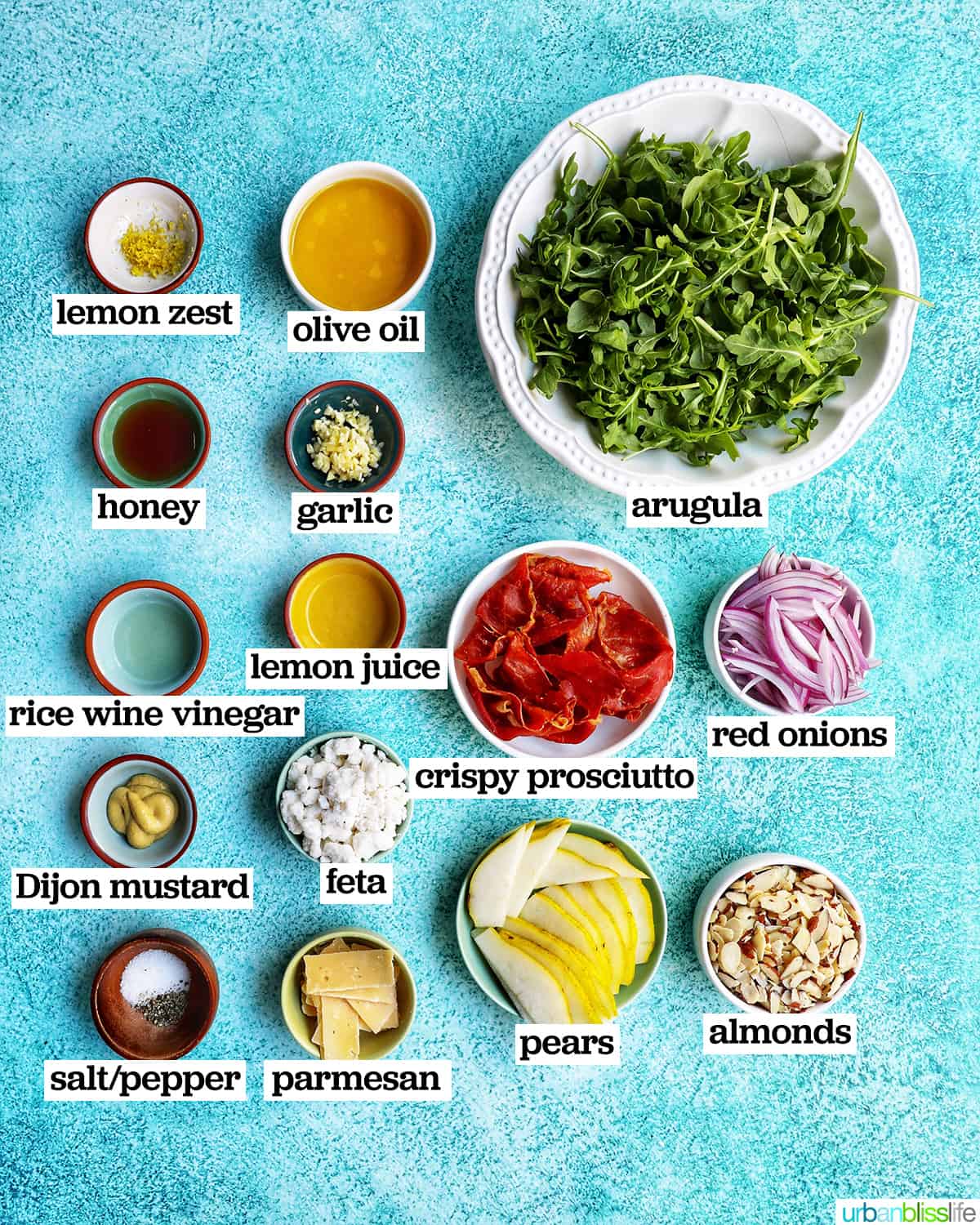 bowls of ingredients to make pear arugula salad.