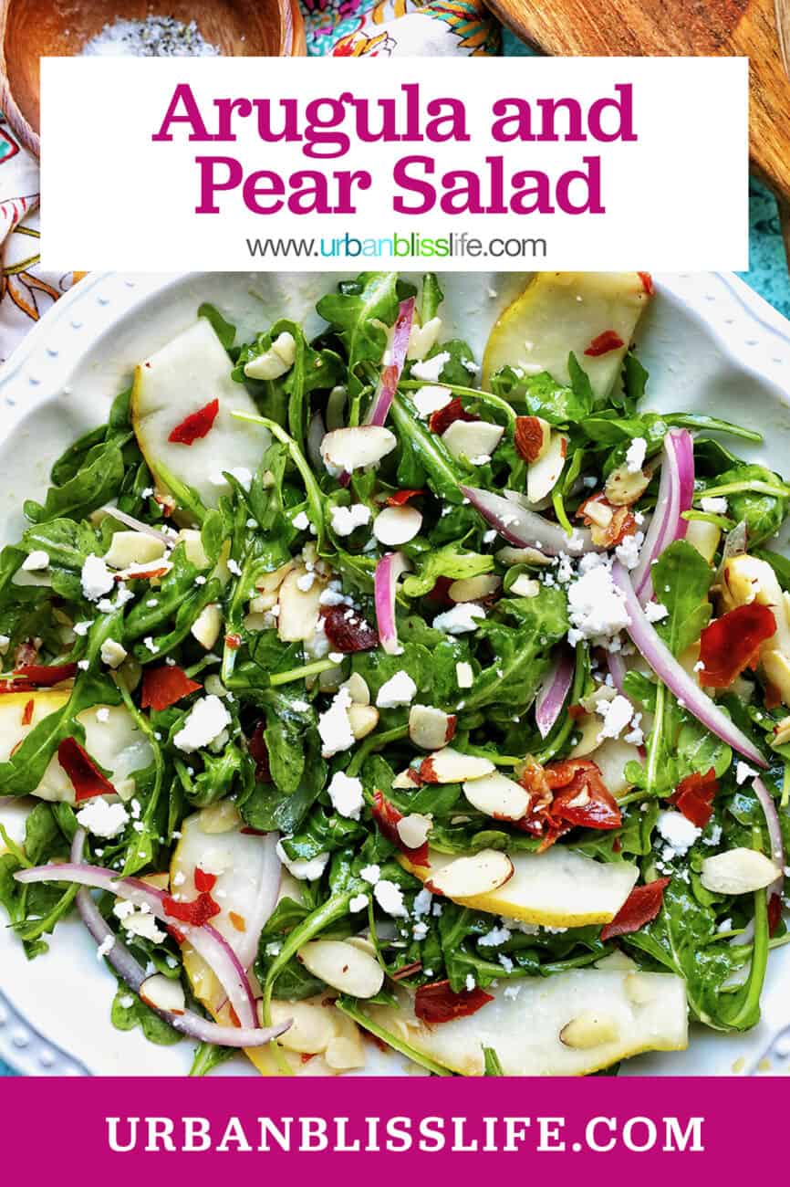 arugula, pears, prosciutto, and red onion salad in a white bowl with title text that reads "Arugula and Pear Salad."