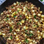 breakfast sausage potato hash in a cast iron skillet.
